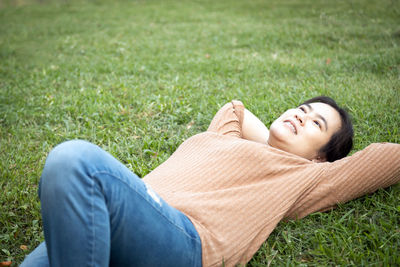 Woman lying on grass