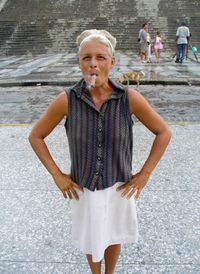 Portrait of woman smoking cigar on street