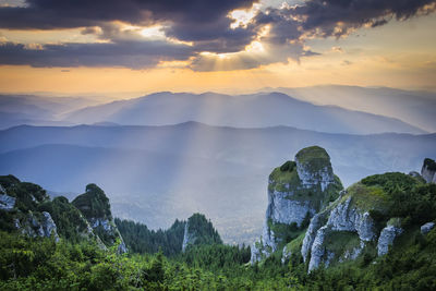 Scenic view of mountains against sky at sunset