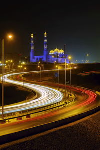 High angle view of light trails on road in city at night