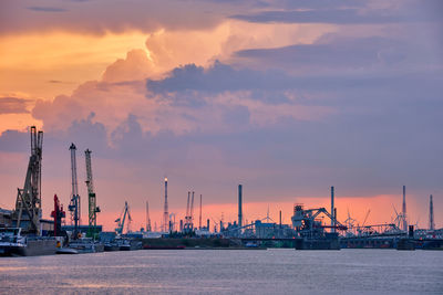 Port of antwerp with harbor cranes in twilight