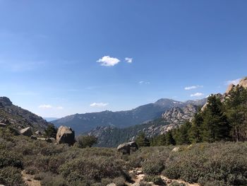 Scenic view of mountains against blue sky