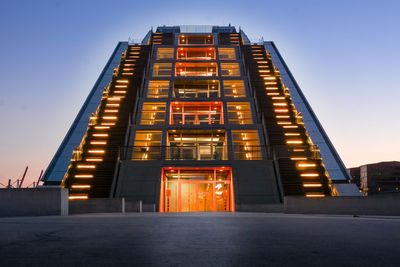 Low angle view of illuminated building against sky at night