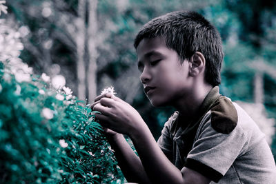 Portrait of boy holding flower