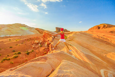 Rear view of woman on landscape against sky