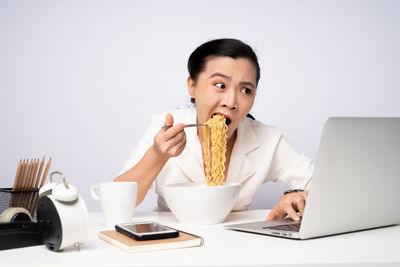 Portrait of young man using laptop