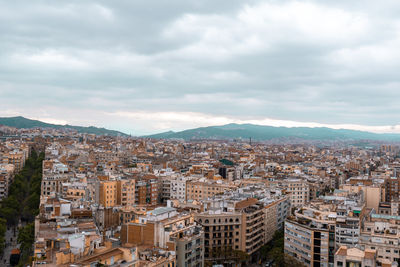 Top view of barcelona city with apartment buildings and mountains in the background