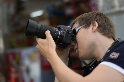 Photographer photographing through camera