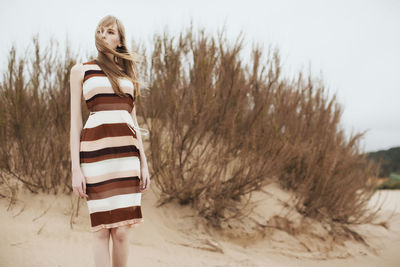 Woman standing on sand at beach