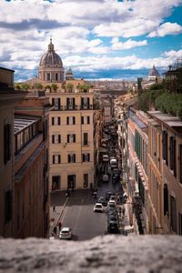 Street amidst buildings in city against sky