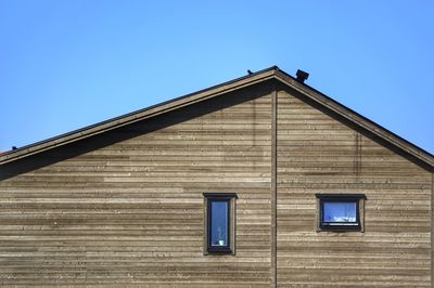 Low angle view of building against clear blue sky