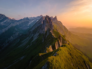 Panoramic view of snowcapped mountains against sky during sunset