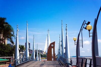 Malecon in city against sky during sunny day