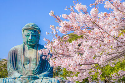 Low angle view of statue against sky