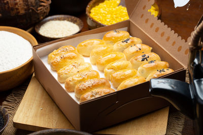 Chinese pastry filled with mung bean paste, taro, and salted egg in the paper box.