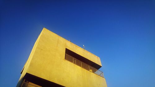 Low angle view of building against clear blue sky