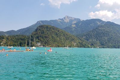 Scenic view of sea and mountains against sky