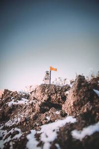 Close-up of rocks on field against clear sky