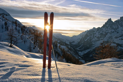 Scenic view of snow covered mountains against sky during sunset