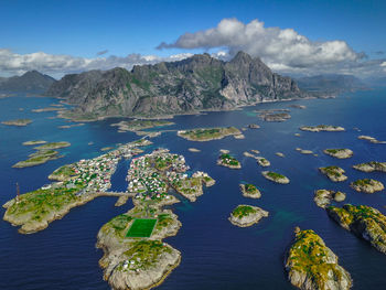 Scenic view of sea and mountains against blue sky