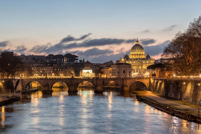 Arch bridge over river in city