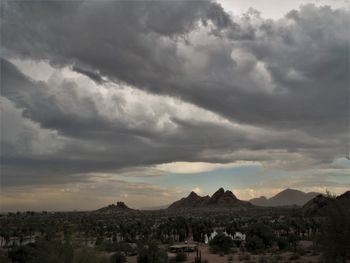 Panoramic view of town against cloudy sky