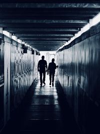 Rear view of silhouette people walking in subway