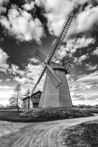 Low angle view of windmill on field against sky