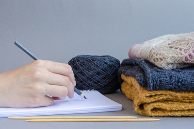 Midsection of man reading book on table