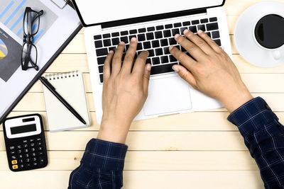 High angle view of person using laptop on table