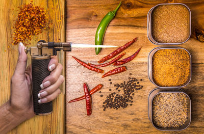 Hot stuff, flame and very hot spices on a wooden board