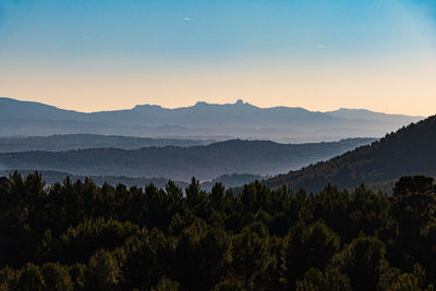Scenic view of mountains against sky at sunset