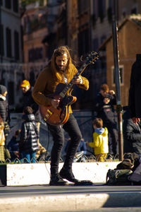Man playing guitar on street