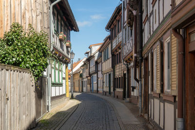 Narrow street amidst buildings against sky