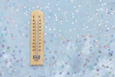 Thermometer shows low plus temperature and christmas decoration. winter holiday weather