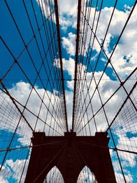 Low angle view of brooklyn bridge against cloudy sky