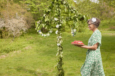 Woman carrying cake outdoors