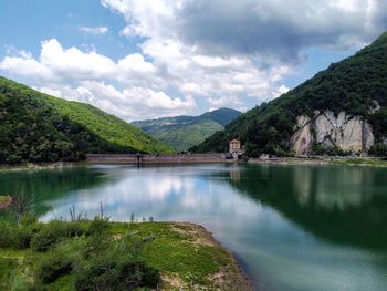 Scenic view of lake and mountains against sky