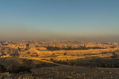 Aerial view of city buildings against clear sky