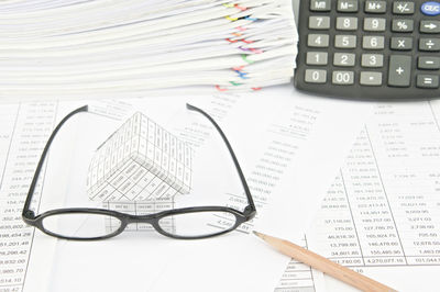 Close-up of eyeglasses and book on table