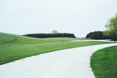 View of fields against clear sky