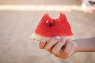 Close-up of hand holding strawberry