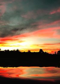 Scenic view of silhouette landscape against orange sky