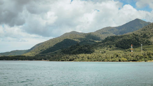 Scenic view of lake and mountains against sky