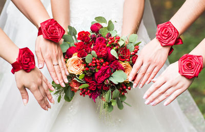 Midsection of bride holding bouquet