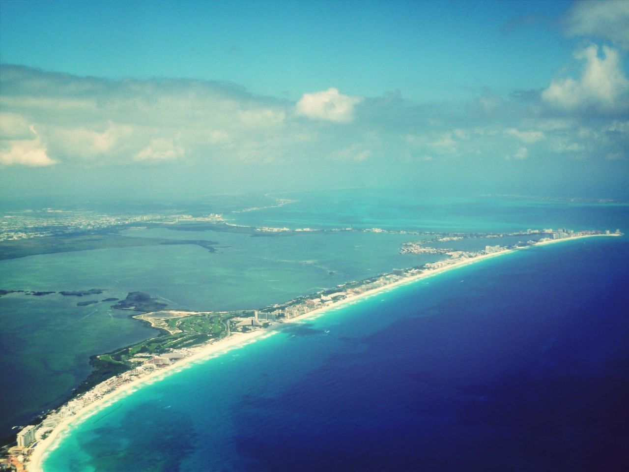 sea, water, scenics, aerial view, sky, high angle view, blue, coastline, beauty in nature, horizon over water, tranquil scene, beach, nature, tranquility, built structure, transportation, cityscape, cloud - sky, city, idyllic