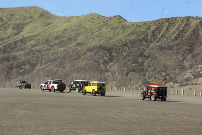 Cars on road against mountains