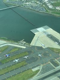 High angle view of airplane flying over city