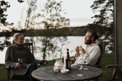 Couple sitting on porch and drinking wine