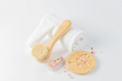 Natural eco beauty treatment. cosmetic products, towel and sea salt on white background, top view. 